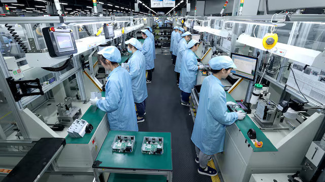 Workers on a factory production line in China